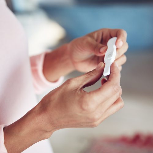 Cropped shot of a woman waiting for the results of a pregnancy test